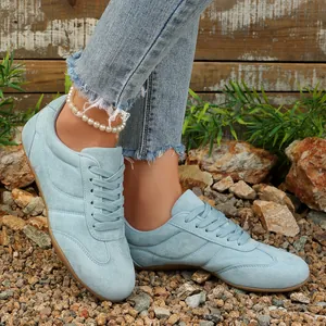 Λεπτομερής κοντινή όψη γαλάζιων σουέτ casual sneakers με κορδόνια για γυναίκες
