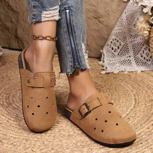 Close-up detail showing the texture of vintage brown suede platform clogs with buckles.
