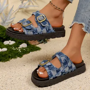 Detailed side view of platform denim slippers with double gold buckles and fringe