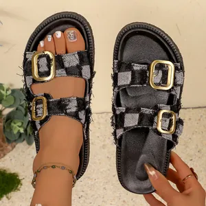 Detailed view of women's checkered sandals with gold buckles and frayed denim edges