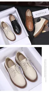 Detailed view of beige women's lace-up oxfords with durable gum soles and white stitching.