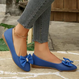Elegant blue pointed-toe ballet flats with decorative bowknot and sparkling rhinestones
