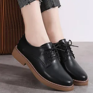 Classic black women's lace-up leather oxfords with durable brown rubber soles for daily wear