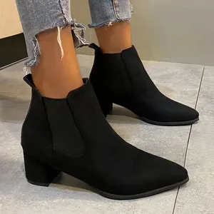 Detailed side view of elegant black suede Chelsea boots with a comfortable block heel