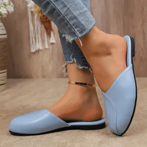 Detailed side view of comfortable light blue flat closed-toe mules for women