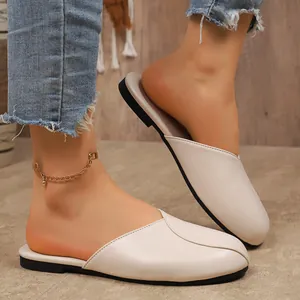 Detail of cream flat closed-toe mules with round toe design for women's summer wear.