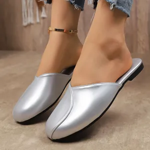 Close-up of silver pointed-toe mules showing the metallic finish and elegant V-cut