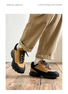 Detail view of men's yellow hiking shoes with height-increasing thick soles