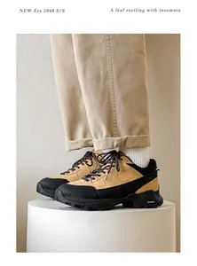 Professional side view of tan and black mens hiking shoes with thick rugged soles