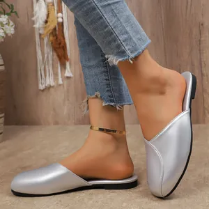 Detail view of silver round-toe flat mules for women with stylish metallic finish