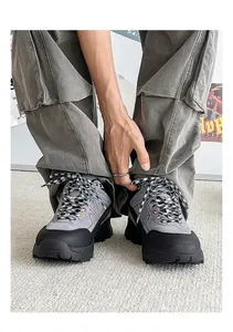 A detailed view showing grey and black outdoor trekking sneakers worn with cargo pants.