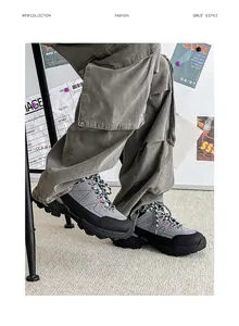 Side view detail of grey and black non-slip hiking boots with mesh and synthetic upper.