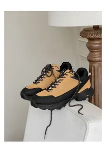 Close-up of tan and black outdoor hiking shoes with thick non-slip soles