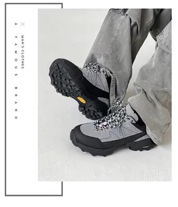 Detailed view of men's gray hiking shoes with chunky non-slip soles for outdoor trekking