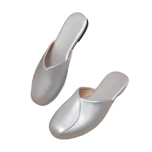 Silver flat closed-toe mules for women with metallic finish and round toe