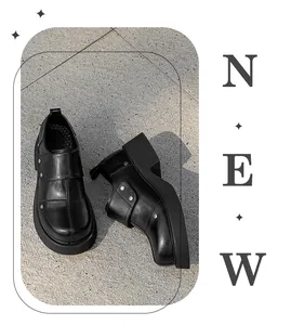 Detail view of black British style leather brogues with round toe and chunky sole