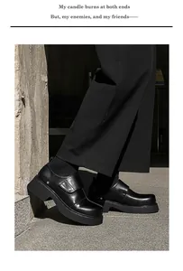 Detail view of men's black British style chunky leather shoes with platform sole