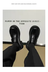 Artistic close-up of men's black British style chunky sole leather round toe dress shoes