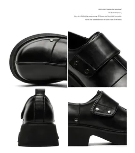 Detail view of black British style leather shoes with rivet accents and thick sole