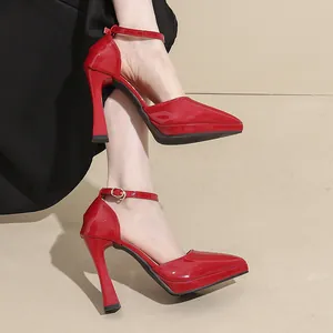 Side view close-up of elegant red patent leather pointed toe high heels with ankle strap