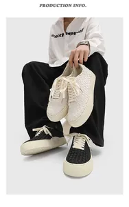 Close-up of handmade woven low-top casual sneakers in black and white colors.