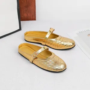 Close-up detail of stylish gold woven mules featuring round toes and adjustable buckle straps