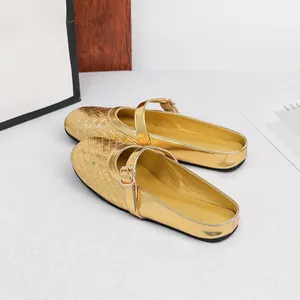 Detailed view of the shiny gold metallic woven flat Mary Jane mules for elegant women.