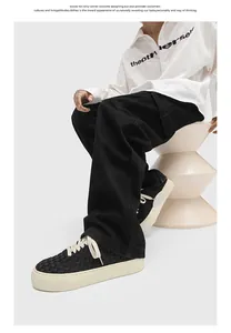 Hand-woven low-top casual sneakers for men, stylish black woven texture and thick cream sole.
