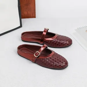 Detailed view of burgundy woven texture flat mules with adjustable Mary Jane buckle strap