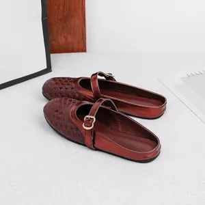 Detailed view of elegant burgundy woven round-toe flat mules for women with buckled strap