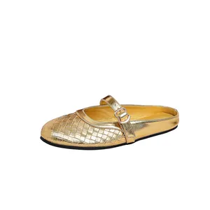 Detailed side view of golden woven round toe mule slippers with elegant buckle strap