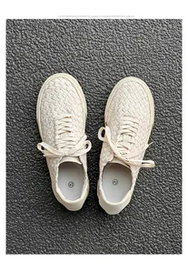 Detailed top view showing the intricate woven texture of beige casual sneakers for men