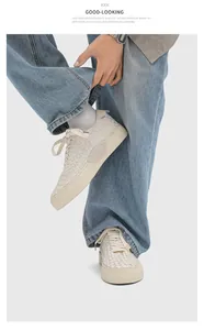 Detailed view of handmade woven cream sneakers worn with blue jeans