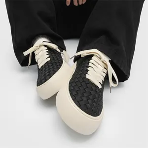 Men's handmade woven low-top casual sneakers with chunky cream laces on white background