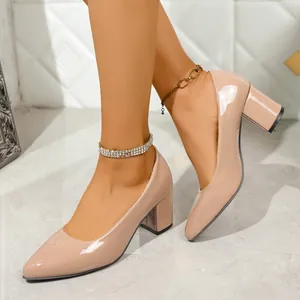Close-up of nude patent leather chunky heel pumps with pointed toe design