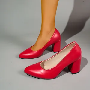 Detail view of elegant red block heel pumps with a pointed toe for a professional look