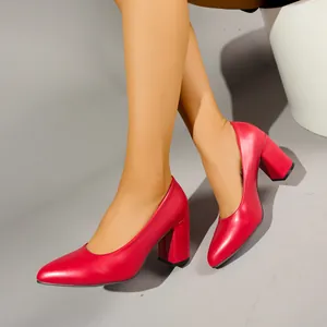 Elegant red pointed-toe block heel pumps worn by a model, perfect for office or evening events