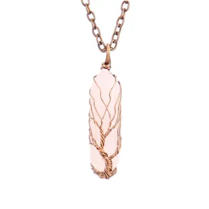 Close-up detail of handmade copper wire wrapped rose quartz crystal tree of life necklace