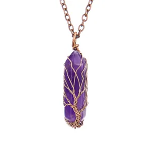 Macro detail of handmade copper wire wrapped amethyst tree of life hexagonal pendant
