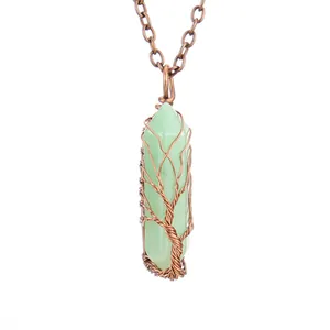 Detailed view showing handmade copper wire wrapped tree of life on green crystal