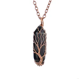 Detailed view of black hexagonal crystal pendant with handmade copper tree of life wire wrap