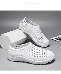 Detailed side view of white breathable EVA clogs on a minimalist grey background