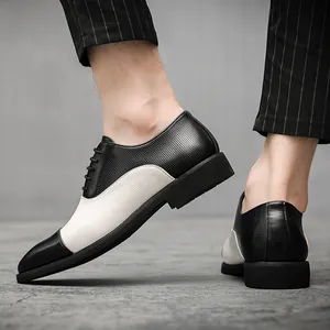 Dettaglio scarpe eleganti uomo stile inglese in pelle traforata bicolore bianco e nero