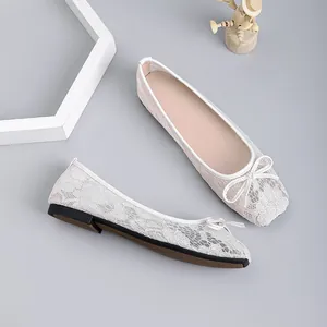 Detail view of elegant lace mesh ballet flats featuring square toe and delicate bow decoration