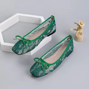 Detail of green mesh ballet flats featuring square toe and lace bow decoration
