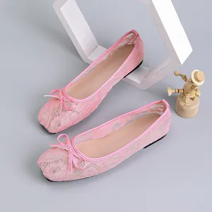 Close-up of pink lace mesh ballet flats featuring delicate bow and square toe design