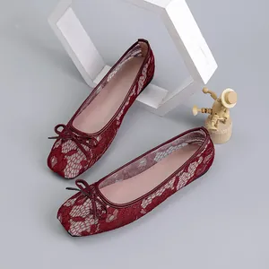Detailed top view of elegant wine red lace mesh ballet flats with square toe and bow accent
