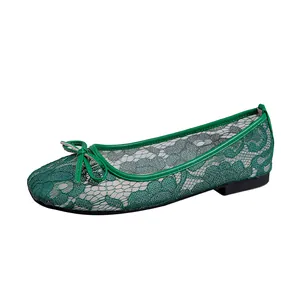 Close-up detail of green mesh ballet flats featuring delicate floral lace and a cute bow