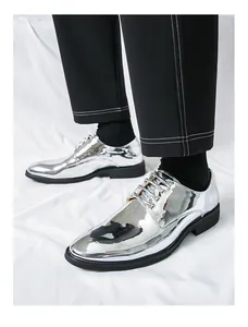 Close-up of men's silver metallic mirror finish dress shoes with black trousers