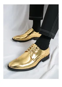 Shiny polished gold pointed-toe dress shoes for men styled with formal black trousers